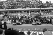 Aston Martin drivers climbing into the cars at the start - #7 Aston Martin DBR1/300 - Roy Salvadori and Jim Clark, #8 Aston Martin DBR1/300 - Ian B. Baillie and Jack Fairman