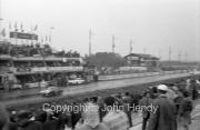 Car at speed on the pit straight, wet