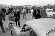 Stirling moss on his scooter in the paddock