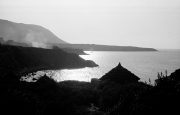 Straw hut silhouetted at dusk