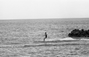 Lady in black swimsuit water-skiing