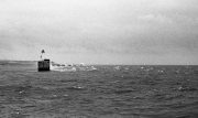 Waves breaking over the harbour wall