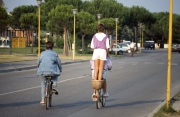 Girl standing on a bicycle