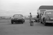 Touring cars - E-Type Jaguar in the paddock (could be #37, Bruce McLaren&apos;s car)