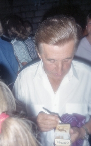 Unknown man signing a cigarette packet