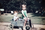 John sitting on a car