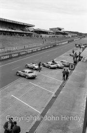 Porsches in position in the pits - #30 Porsche 718 RS 61/4 Coupe (Jo Bonnier and Dan Gurney). #32 Porsche 718 RS 61/4 Coupe (Edgar Barth and Hans Herrmann). #33 Porsche 718 RS 61/4 Spyder (Masten Gregory and Bob Holbert)