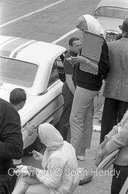 Young ladies in the pits, Jack Sears in the polo shirt.