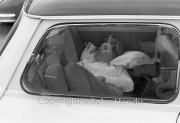 Young lady asleep in the back of a Mini