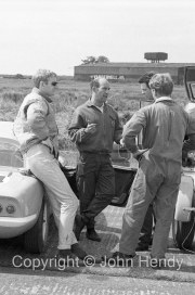 Stirling Moss and John Whitmore (in sunglasses). Moss tested for Lotus in 1963, after recovering from his 1962 crash at Goodwood, but retired without racing again.