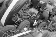 Formula 1 - #1 Cooper T53 Climax FPF (Jack Brabham) in the paddock, with Jack Brabham (back turned) in the background