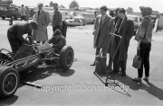 Formula Junior car stripped, with onlookers