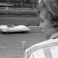 A young lady watching the racing