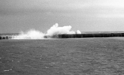 Waves breaking over the harbour wall
