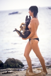 Topless lady carrying dog