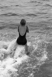 Lady in black swimsuit water-skiing