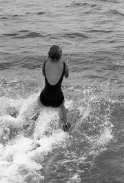 Lady in black swimsuit water-skiing